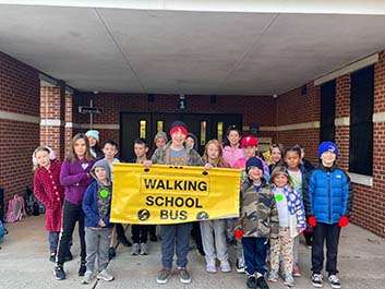 Students with Walking School Bus banner