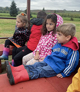 Students sitting in a wagon going for a ride